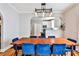 Dining room featuring hardwood floors, an ornate light fixture, and an archway to the kitchen at 32 Howell Se St, Atlanta, GA 30312