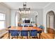 Elegant dining room featuring a wood table, stylish blue chairs, and an open layout for entertaining at 32 Howell Se St, Atlanta, GA 30312