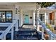 Inviting front porch featuring black trim and a bright teal front door at 32 Howell Se St, Atlanta, GA 30312