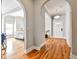 Inviting hallway with beautiful hardwood floors and arched doorways, creating a seamless flow throughout the home at 32 Howell Se St, Atlanta, GA 30312