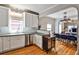 Bright kitchen with white cabinets, stainless steel appliances, and an adjacent dining area, perfect for modern living at 32 Howell Se St, Atlanta, GA 30312