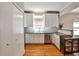 Bright kitchen features white cabinets, stainless steel appliances, and subway tile backsplash at 32 Howell Se St, Atlanta, GA 30312