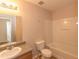 Well-lit bathroom with a shower-tub combo, oak cabinets, and tile flooring at 5171 Hanover St, Atlanta, GA 30349
