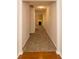 Hallway view towards the living room fireplace with wood and carpet flooring at 5171 Hanover St, Atlanta, GA 30349