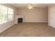 Spacious living room featuring a fireplace, ceiling fan, and large window at 5171 Hanover St, Atlanta, GA 30349