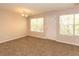 The living room features plush carpeting and two large windows at 5171 Hanover St, Atlanta, GA 30349