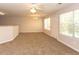 The living room features plush carpeting, multiple windows and a ceiling fan at 5171 Hanover St, Atlanta, GA 30349