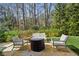 Comfortable backyard patio featuring a stone fire pit and lounge seating perfect for outdoor gathering at 1811 Paces Ferry Se Ct, Smyrna, GA 30080