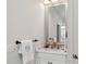 Bright bathroom featuring white vanity with marble countertop and elegant fixtures at 1811 Paces Ferry Se Ct, Smyrna, GA 30080