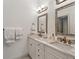 Elegant bathroom featuring double sinks, marble countertops, and framed mirrors at 1811 Paces Ferry Se Ct, Smyrna, GA 30080