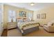 Comfortable bedroom with neutral carpet, natural light, and a cozy chair at 1811 Paces Ferry Se Ct, Smyrna, GA 30080