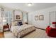 Bright bedroom featuring a floral bedspread, matching curtains, and a cozy red armchair at 1811 Paces Ferry Se Ct, Smyrna, GA 30080