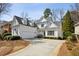 Inviting two-story home featuring white siding, manicured landscaping, and a spacious driveway at 1811 Paces Ferry Se Ct, Smyrna, GA 30080