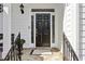 Elegant black front door with decorative sidelights and brass hardware at 1811 Paces Ferry Se Ct, Smyrna, GA 30080