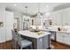 Kitchen with an island and breakfast bar, with stainless appliances and white cabinetry at 1811 Paces Ferry Se Ct, Smyrna, GA 30080