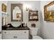 Stylish powder room featuring unique sink basin, vanity, and decorative mirror at 1811 Paces Ferry Se Ct, Smyrna, GA 30080