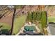 Aerial perspective of a property showcasing the expansive backyard with a pool, spa, and mature trees at 3323 Acorn Falls Dr, Marietta, GA 30062