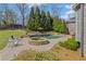 Relaxing backyard with a custom pool, stone spa, mature landscaping, and inviting lounge area at 3323 Acorn Falls Dr, Marietta, GA 30062