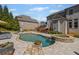 Well-maintained backyard pool with spa and waterfall feature, surrounded by lush landscaping at 3323 Acorn Falls Dr, Marietta, GA 30062