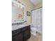 Well-lit bathroom with granite countertops, a patterned shower curtain, and tile flooring at 3323 Acorn Falls Dr, Marietta, GA 30062