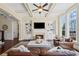 Inviting living room with built-in shelving, cozy fireplace, and natural light streaming through large windows at 3323 Acorn Falls Dr, Marietta, GA 30062