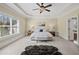 Spacious main bedroom featuring tray ceiling, plush carpet, and large windows at 3323 Acorn Falls Dr, Marietta, GA 30062