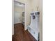 Mudroom with a white bench and storage; dark wood floors flow into the hallway at 3323 Acorn Falls Dr, Marietta, GA 30062