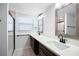 Bathroom featuring double sinks, dark wood cabinets, modern fixtures, and walk-in shower at 4554 Mountain Creek Ne Dr, Roswell, GA 30075