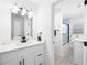 This bathroom features a floating vanity with a marble countertop, modern fixtures and lighting at 4554 Mountain Creek Ne Dr, Roswell, GA 30075