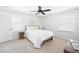 Bright bedroom features a ceiling fan, neutral decor, and plush carpeting at 4554 Mountain Creek Ne Dr, Roswell, GA 30075