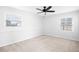 Bright bedroom featuring neutral carpeting, two windows, and a ceiling fan at 4554 Mountain Creek Ne Dr, Roswell, GA 30075