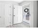 Bright entryway with white door, hardwood floors, closet and decorative wreath at 4554 Mountain Creek Ne Dr, Roswell, GA 30075