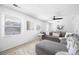 Well-lit living room with a gray sectional, ceiling fan, and natural light from large windows at 4554 Mountain Creek Ne Dr, Roswell, GA 30075