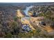 Expansive aerial view of a lakeside estate, complete with a manicured golf course and stately residence at 490 Birkdale Dr, Fayetteville, GA 30215