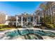 A luxurious backyard featuring a stunning pool, spa, and elegant white columns that provides a picturesque outdoor space at 490 Birkdale Dr, Fayetteville, GA 30215