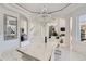 Elegant dining room with modern chandelier, marble-topped table and comfortable seating for a dinner party at 490 Birkdale Dr, Fayetteville, GA 30215