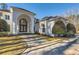 Grand home exterior featuring a circular driveway, manicured lawn, and architectural details at 490 Birkdale Dr, Fayetteville, GA 30215