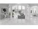 Expansive foyer with marble floors, elegant columns, and views of the living room and dining areas at 490 Birkdale Dr, Fayetteville, GA 30215