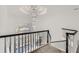 Elegant foyer with a winding staircase, black wood railing, white spindles, and a breathtaking chandelier at 490 Birkdale Dr, Fayetteville, GA 30215