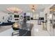 Spacious kitchen with black and white marble, stainless steel appliances, and stunning light fixtures at 490 Birkdale Dr, Fayetteville, GA 30215