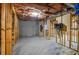 Unfinished basement featuring exposed insulation, cement floors, and wood framing at 11385 Donnington Dr, Duluth, GA 30097