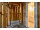 Unfinished basement with framed walls leading to a full bathroom at 11385 Donnington Dr, Duluth, GA 30097