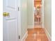 Hallway view of a bathroom featuring a pedestal sink, tile flooring, and natural light at 11385 Donnington Dr, Duluth, GA 30097