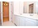Bathroom featuring double sinks with white cabinets and views into another room at 11385 Donnington Dr, Duluth, GA 30097