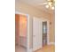 This bathroom has a vanity sink with white cabinets, with a doorway leading to another room at 11385 Donnington Dr, Duluth, GA 30097