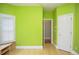 Bedroom featuring bamboo floors, a bright green wall, and an open doorway to another room at 11385 Donnington Dr, Duluth, GA 30097