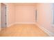 A light and airy bedroom has wood floors and neutral walls at 11385 Donnington Dr, Duluth, GA 30097