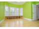 Bedroom with bamboo floors, a window seat, and bright green walls, with a doorway at 11385 Donnington Dr, Duluth, GA 30097