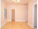 Sunlit bedroom with wood floors, neutral walls, and bright white trim at 11385 Donnington Dr, Duluth, GA 30097