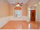 Elegant dining room featuring wainscoting, hardwood floors, and a window with plantation shutters at 11385 Donnington Dr, Duluth, GA 30097